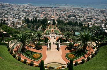 Visitors walk in the gardens in the Baha'i temple in the northern Israeli city of Haifa on July 14, 2008. (AP)