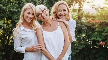 Three women enjoying outdoors, talking and laughing stock photo