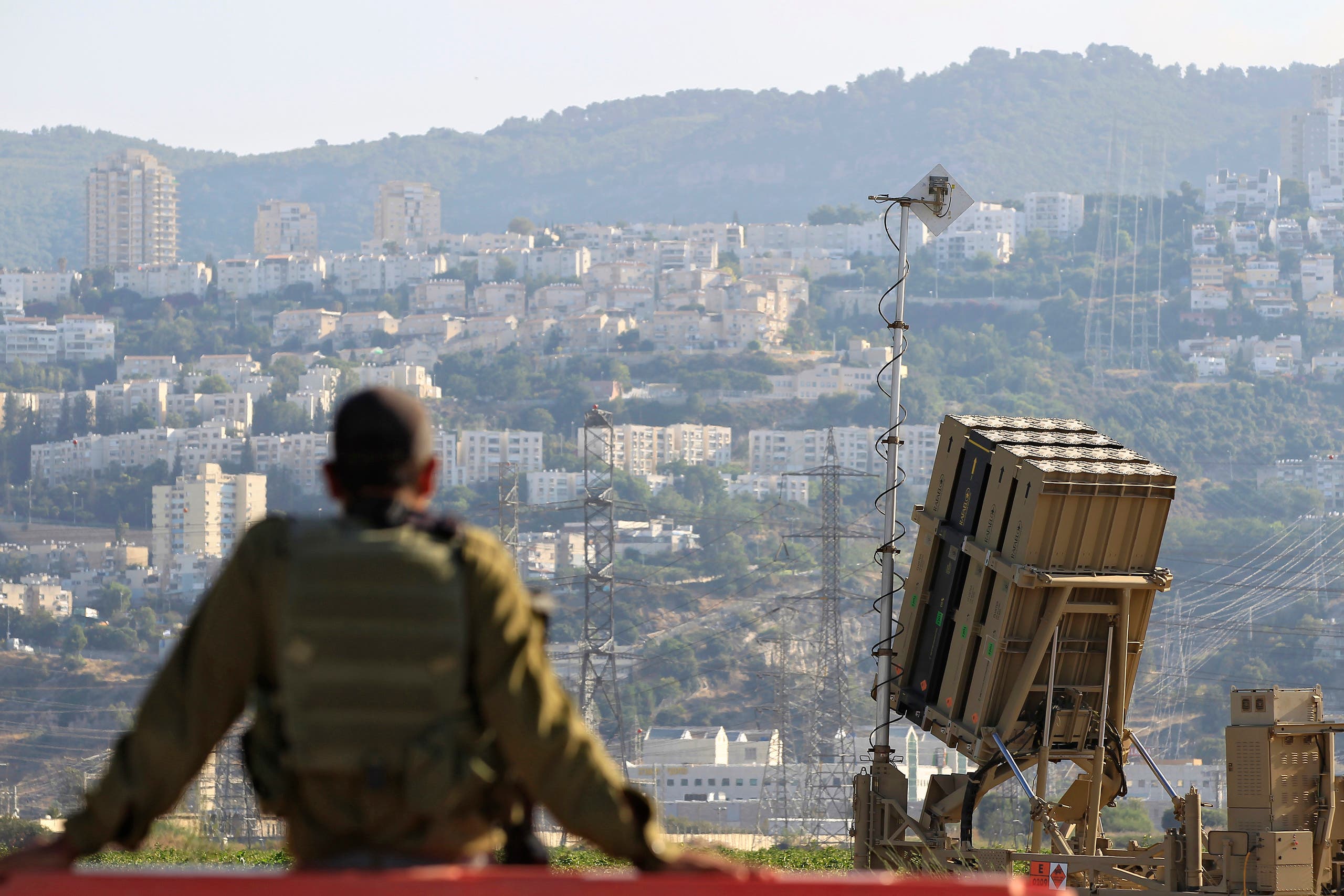 An Israeli soldier is seen next to an Iron Dome rocket interceptor battery deployed near the northern Israeli city of Haifa on Aug. 28, 2013. (AP)