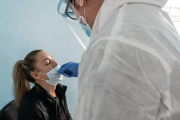 Alaska Airlines passenger Nicole Diddle receives a COVID-19 rapid test prior to her flight at Portland International Airport on November 25, 2020 in Portland, Oregon. (File photo: AFP)