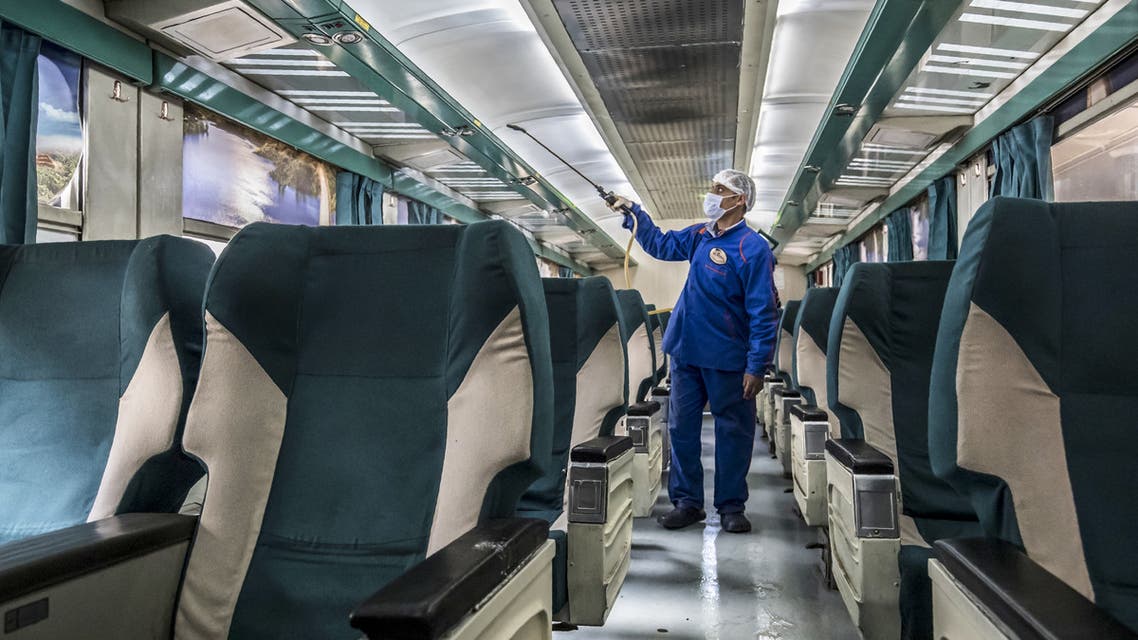 An Egyptian worker sprays disinfectant inside a train at Cairo's Ramses railway station in the Egyptian capital on March 20, 2020. (AFP)