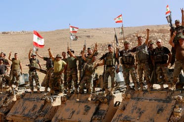 Lebanese army soldiers flash victory signs as they rest on top of an armoured personnel carrier in northeast Lebanon, Aug. 28, 2017. (AP)
