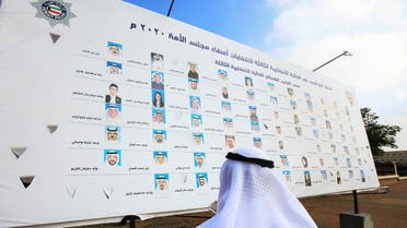 A Kuwaiti man looks at a billboard featuring the candidates running for parliamentary elections in Kuwait City. (AFP)