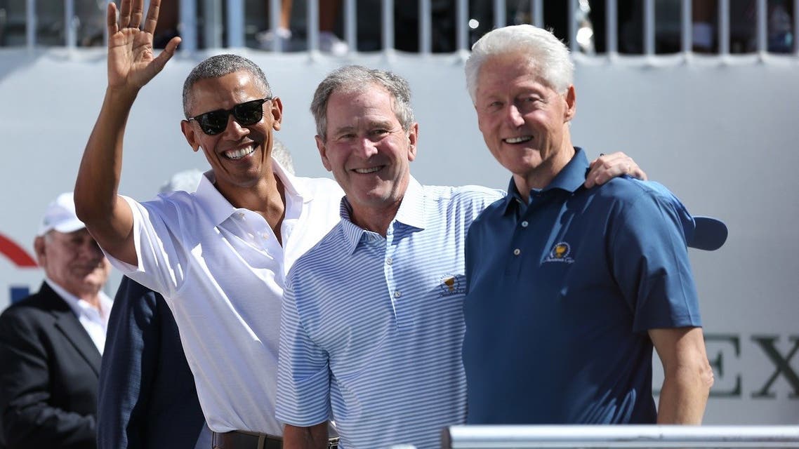 Former U.S. Presidents (from Left) Barack Obama and George W. Bush and Bill Clinton smile during the first round foursomes match of The President's Cup golf tournament at Liberty National Golf Course. Mandatory Credit: Bill Streicher-USA TODAY Sports
