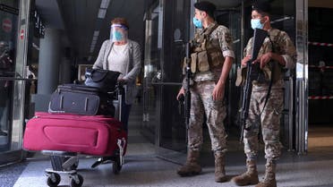 Lebanese soldiers stand guard as a woman leaves the Rafik Hariri International Airport in Beirut, Lebanon, July 1, 2020. (AP)