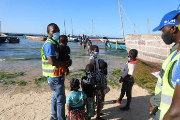 This handout picture taken on November 6, 2020 in Pemba, northern Mozambique, by IOM (International Organization for Migration) shows internally displaced people being assisted by the IOM Displacement Tracking Matrix (DTM) team. (Sandra Black/IOM/AFP)