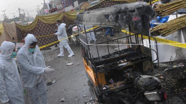 Pakistani investigators examine the site of bomb explosion in Rawalpindi, Pakistan, Friday, Dec. 4, 2020. A roadside bomb exploded near a busy bus terminal in the Pakistani garrison city of Rawalpindi, killing and and wounding some persons, police said. (The Associated Press/A.H. Chaudary)