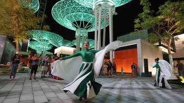 Women in Saudi National flag colours and logo outfit, perform during Saudi National Day celebrations at the Bluewaters Island in Dubai, United Arab Emirates, Friday, Sept. 20, 2019. (AP)
