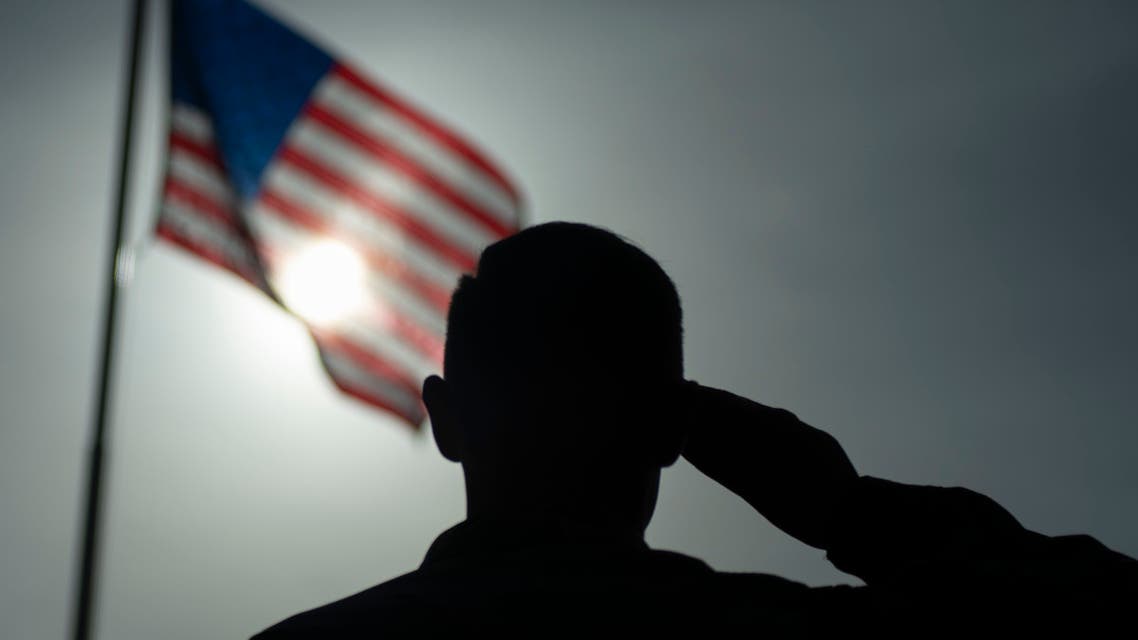This US Air Force file photo obtained January 5, 2020 shows US Air Force Staff Sgt. Devin Boyer, 435th Air Expeditionary Wing photojournalist, as he salutes the flag at Camp Simba, Kenya, on August 26, 2019. Jihadists from Somalia's Al-Shabaab group on January 5, 2020 stormed a military base used by US forces in Kenya's coastal Lamu region, killing three American citizens and destroying several aircraft and military vehicles, officials said. Attackers breached heavy security at Camp Simba at dawn but were pushed back and four jihadists killed, said army spokesman Colonel Paul Njuguna. The American military, however, said three US citizens died in the attack including a service member and two civilian defence contractors.