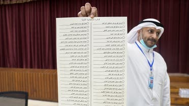 A Kuwaiti official holds the ballot for the 2nd constituency at a polling station during parliamentary elections in Kuwait City. (Reuters)
