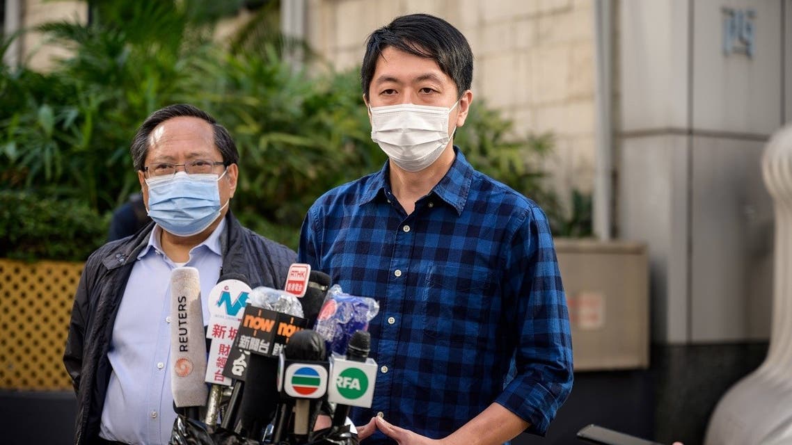 Former lawmaker from Hong Kong's pro-democracy opposition Ted Hui (R), accompanied by veteran pro-democracy politician Albert Ho (L), speaks to the media as he leaves the Western Police Station in Hong Kong, November 18, 2020. (Anthony Wallace/AFP)
