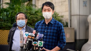 Former lawmaker from Hong Kong's pro-democracy opposition Ted Hui (R), accompanied by veteran pro-democracy politician Albert Ho (L), speaks to the media as he leaves the Western Police Station in Hong Kong, November 18, 2020. (Anthony Wallace/AFP)