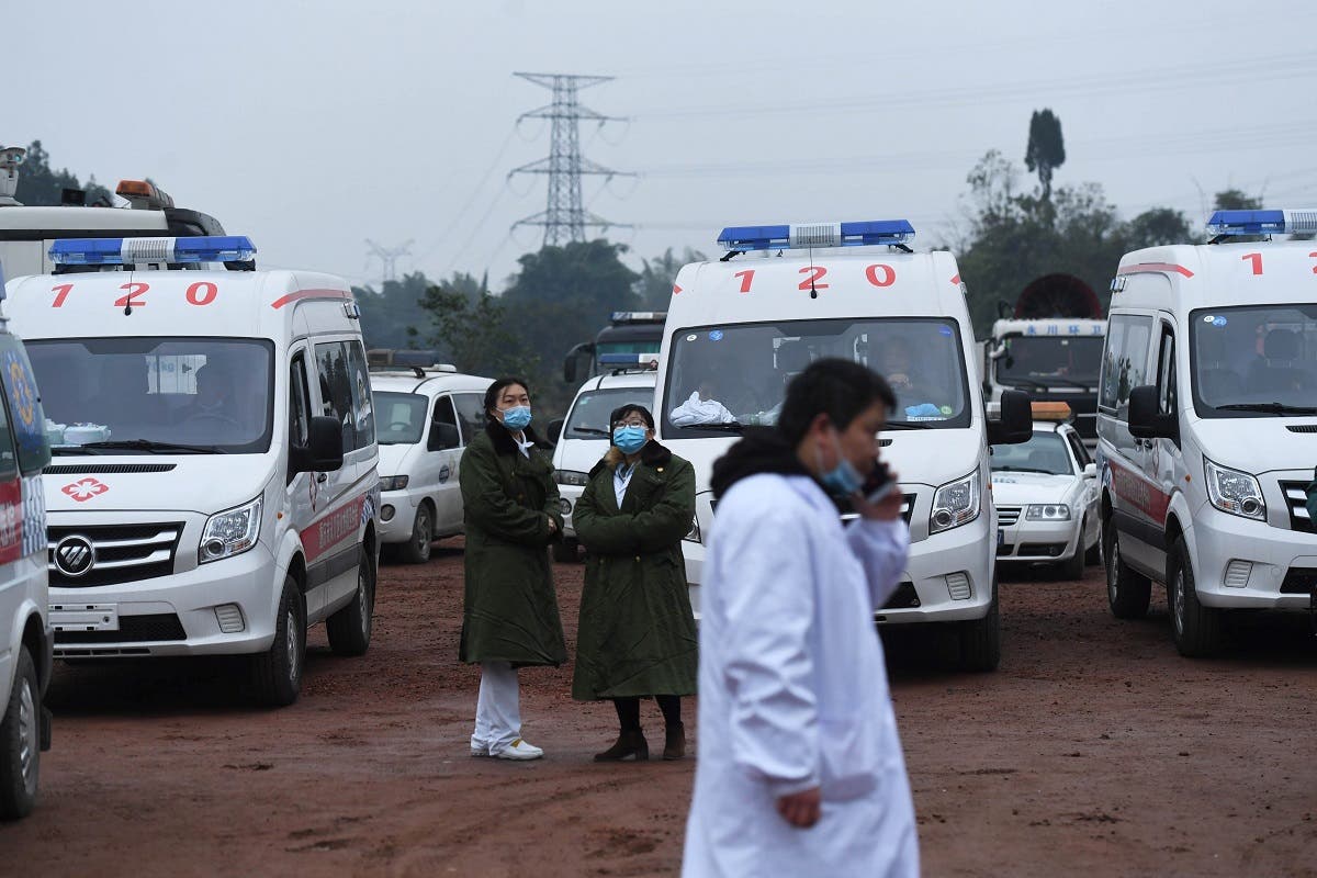 A file photo shows rescue personnel wait beside parked ambulances outside the Diaoshuidong coal mine in southwestern China’s Chongqing on December 5, 2020. (STR/AFP)
