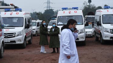 Rescue personnel wait beside parked ambulances outside the Diaoshuidong coal mine in southwestern China’s Chongqing on December 5, 2020. (STR/AFP)