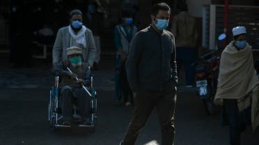 People wearing facemasks as a preventive measure against coronavirus leave from a hospital in Islamabad on November 26, 2020. (Aamir Qureshi/AFP)