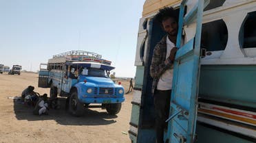 An Ethiopian refugee looks out of a bus window which transports him from the Hamdeyat refugee transit camp, which houses refugees fleeing the fighting in the Tigray region, on the border in Sudan, December 1, 2020. (Reuters/Baz Ratner)