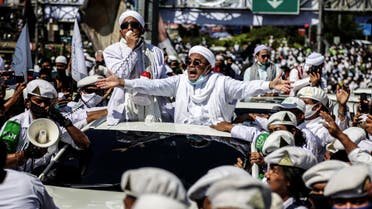 Muslim cleric Rizieq Shihab (C), leader of the Indonesian hardline organisation FPI (Front Pembela Islam or Islamic Defenders Front), gestures to supporters as he arrives to inaugurate a mosque in Bogor on November 13, 2020. (AFP)