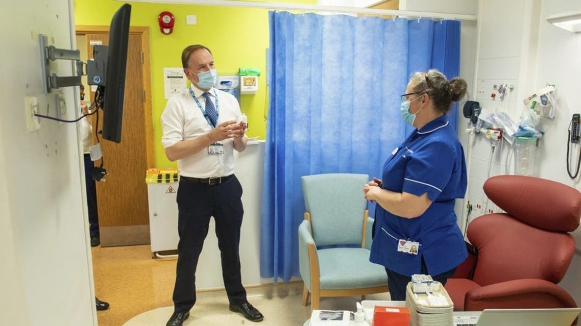 Sir Simon Stevens, the Chief Executive of the National Health Service in England, looks at the freezer facility at the Royal Free Hospital in London ahead of the roll out of the coronavirus vaccine, Monday Dec. 7, 2020. (AP)