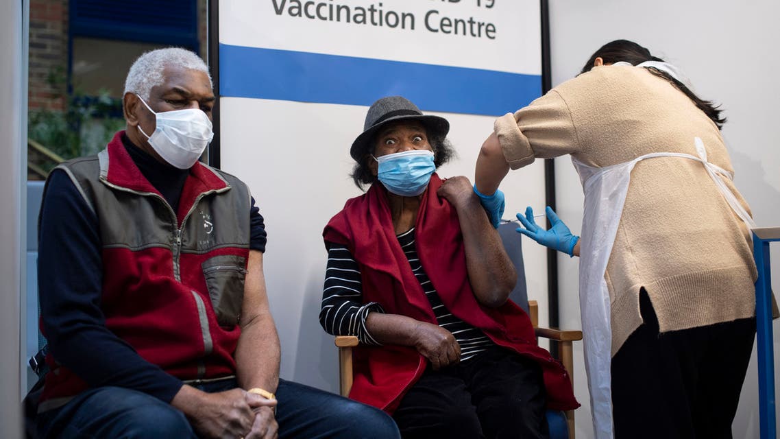 Lorna Lucas, 81, reacts as she receives the first of two Pfizer/BioNTech COVID-19 vaccine jabs shortly before her husband, Winston also has one administered at Guy's Hospital in London, Tuesday, Dec. 8, 2020. (AP)