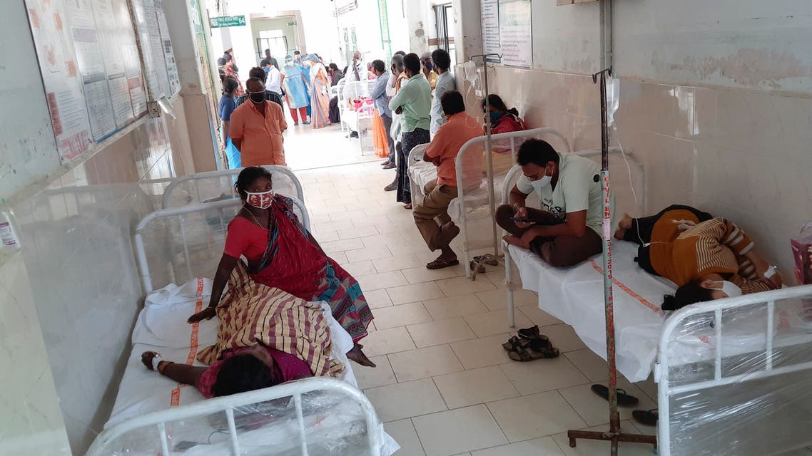 Patients and their bystanders are seen at the district government hospital in Eluru, Andhra Pradesh state, India, Sunday, Dec.6, 2020. Over 200 people have been hospitalized due to an unidentified illness in this ancient city famous for its hand woven products. (AP Photo)