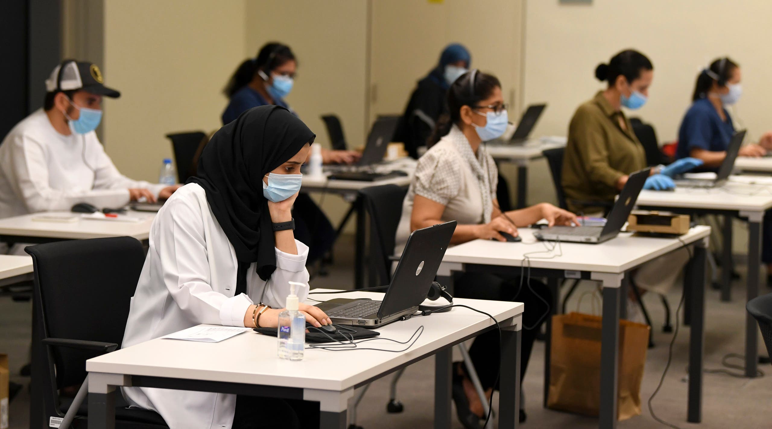 Employees at the Dubai COVID-19 Command and Control Center at Mohammed bin Rashid University in the Gulf emirate on May 20, 2020. (File photo: AFP)