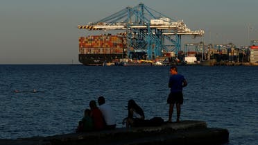 A man fishes from a jetty as containers are unloaded from the container ship MSC Bari at Malta Freeport in Birzebbuga, Malta . (File photo: Reuters)