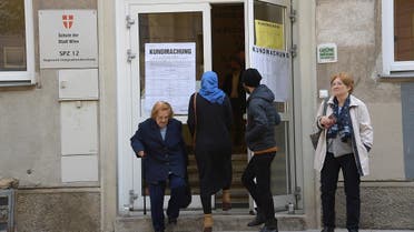 A woman wearing a headscarf leaves a polling station as two elderly women leave the building during general elections in Vienna, Austria, on October 15, 2017. (AFP)