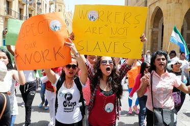 Migrant domestic workers hold placards and chant slogans during a parade to support the rights of migrant domestic workers, on May Day in downtown Beirut, Lebanon May 1, 2016. (Reuters)