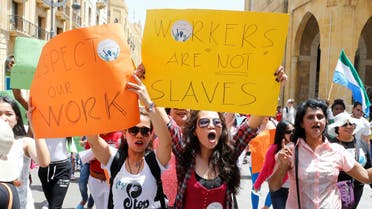 Migrant domestic workers hold placards and chant slogans during a parade to support the rights of migrant domestic workers, on May Day in downtown Beirut, Lebanon May 1, 2016. (Reuters)