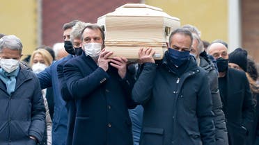 His former teammates in the Italian winning World Cup team, from left, Marco Tardelli, Antonio Cabrini, Giampiero Marini and Alessandro Altobelli carry the coffin of Paolo Rossi as it leaves the church after his funeral service, in Vicenza, Italy, Saturday, Dec. 12, 2020. Paolo Rossi, who led Italy to the 1982 World Cup title and later worked as a soccer commentator in his home country, died at the age of 64. (Paola Garbuio/LaPresse via AP)