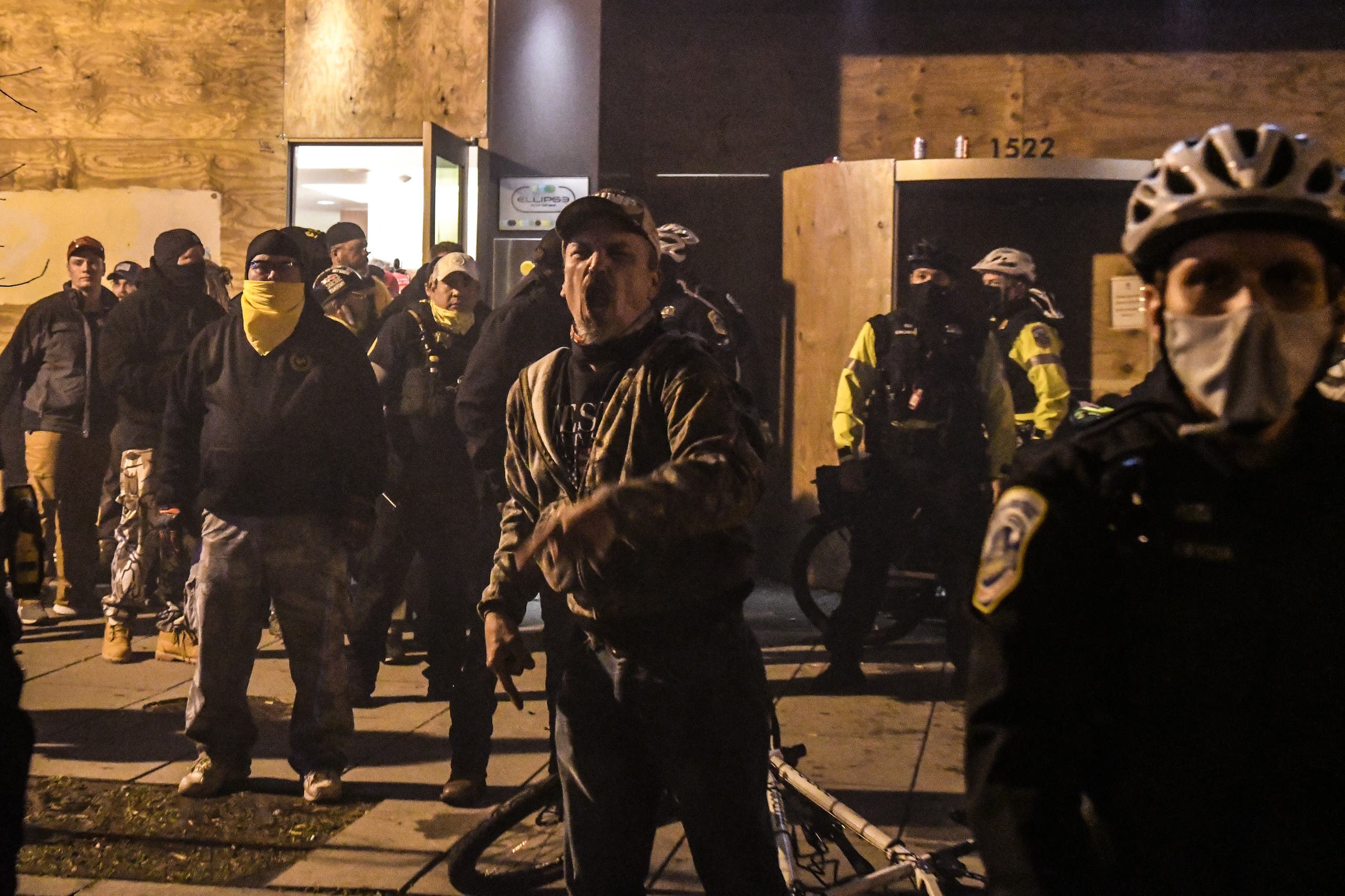 Members of the Proud Boys yell in front of a hotel during a protest on December 12, 2020 in Washington, DC. (AFP)