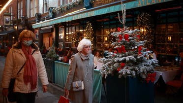 Women walk outside a restaurant following the coronavirus disease (COVID-19) outbreak in London, Britain, on December 15, 2020. (Reuters)