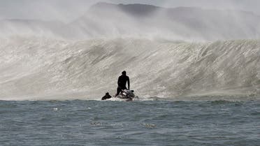 A rescue jet-ski pulls a surfer out of the impact zone after the surfer rode a big wave at Sunset. (File photo: AFP)