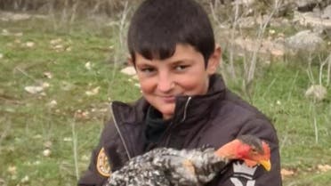 Hussein Chartouni with one of his chickens in Lebanon. (Twitter)