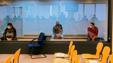 Mohamed Houli Chemlal, left, Driss Oukabir, centre and Said Ben Iazza, right sit behind a glass panel inside the national court at the start of a trial in San Fernando de Henares on the outskirts of Madrid, Spain, Tuesday November 10, 2020. (Fernando Villar, pool photo via The Associated Press)