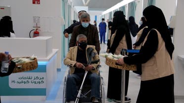 A man in a wheelchair leaving after he received dose of a coronavirus disease (COVID-19) vaccine, in Riyadh. (Reuters)