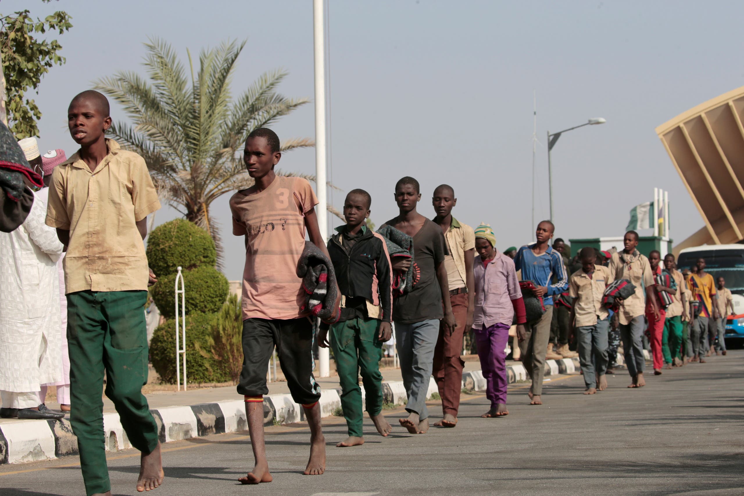 Freed Nigerian schoolboys walk after they were rescued by security forces in Katsina, Nigeria on December 18, 2020. (Reuters)