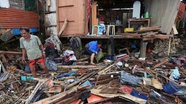 Residents salvage items from their destroyed house after tropical depression Vicky hit Lapu-Lapu City on Saturday. (AFP)