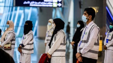 A handout picture provided by the Saudi Ministry of Media on July 25, 2020, shows members of the medical team from Saudi Health ministry at the Red Sea coastal city of Jeddah's King Abdulaziz International Airport. (AFP)