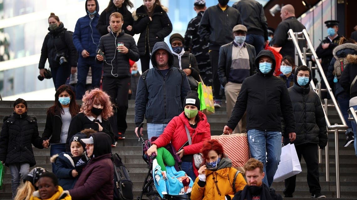 People carrying bags walk down the stairs outside the Westfield Stratford City shopping center, amid the coronavirus outbreak in London, Britain. (Reuters)