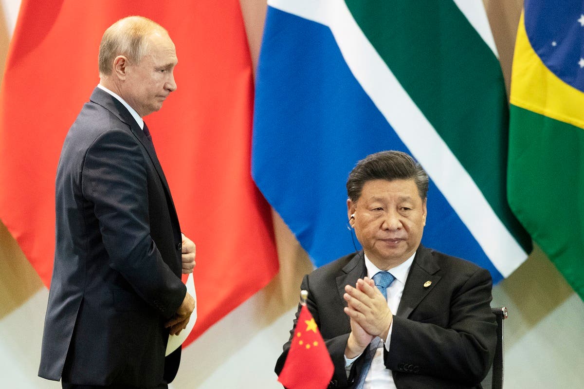 China’s President Xi Jinping (right), and Russia’s President Vladimir Putin attend a meeting with members of the Business Council and management of the New Development Bank during the BRICS emerging economies at the Itamaraty palace in Brasilia, Brazil, on November 14, 2019. (AP)