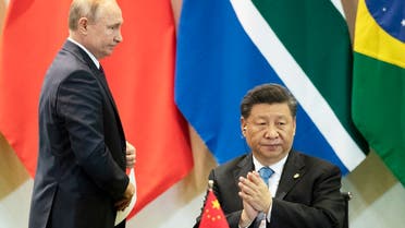 China’s President Xi Jinping (right), and Russia’s President Vladimir Putin attend a meeting with members of the Business Council and management of the New Development Bank during the BRICS emerging economies at the Itamaraty palace in Brasilia, Brazil, on November 14, 2019. (AP)