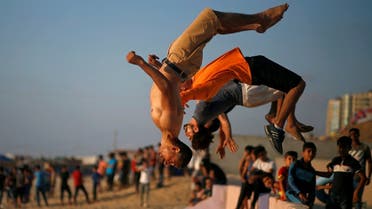 Palestinian men demonstrate their parkour skills on a beach as the coronavirus  restrictions ease in Gaza City. (File photo: Reuters)