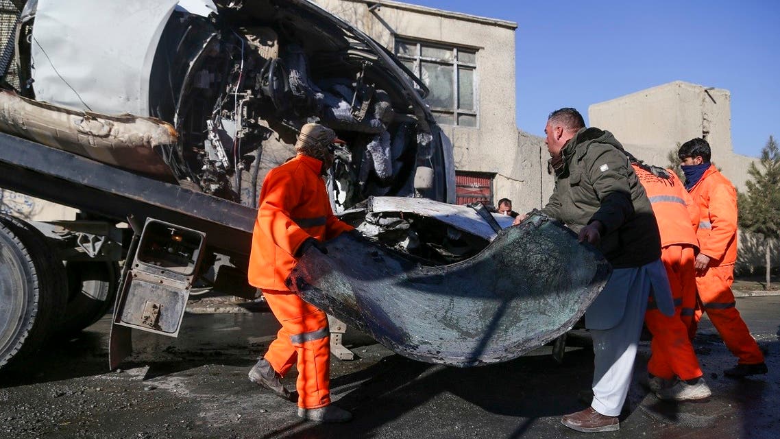 Municipal workers clean up debris at the site of a bomb attack in Kabul on December 22, 2020. (AFP)