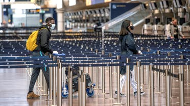 Passengers are pictured wearing protective masks at the Arlanda airport, north of Stockholm, while the spread of the coronavirus disease (COVID-19) continues in Stockholm, Sweden. (Reuters)