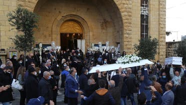 Men carry the coffin of Joe Bejjany, a 36-year-old telecoms employee and freelance photographer, during his funeral in the village of Kahaleh, Lebanon December 22, 2020. (Reuters)