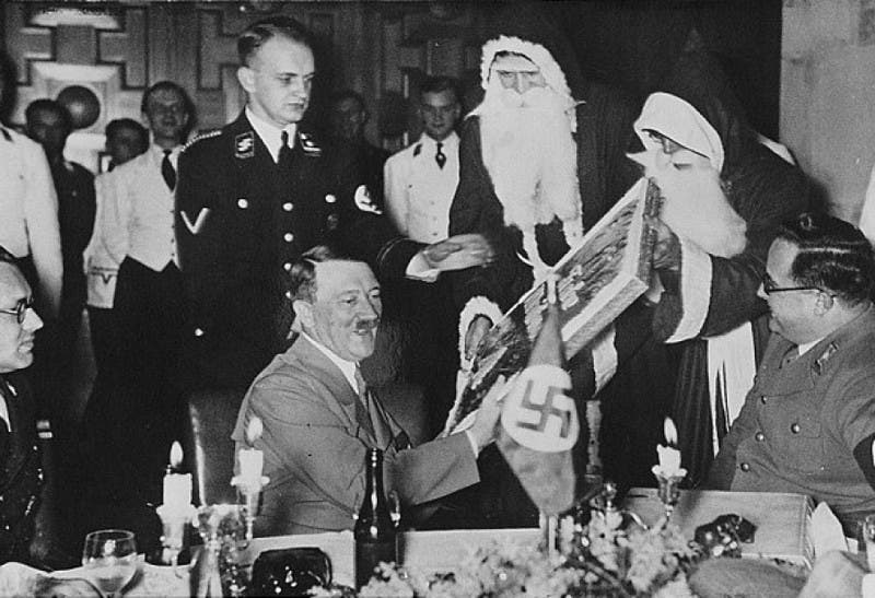 Hitler while receiving a gift from Santa Claus