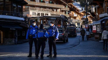 Police officers stand in the street in the Alpine resort of Verbier well known by British ski holiday makers, on December 22, 2020. (AFP)
