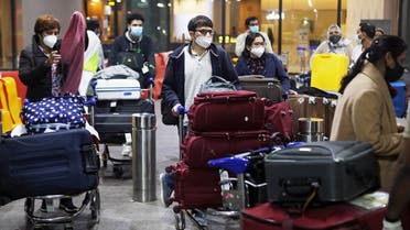 Passengers wearing protective face masks wait to exit upon arrival at Chhatrapati Shivaji Maharaj International Airport after India cancelled all flights from the UK over fears of a new strain of the coronavirus, in Mumbai, India, December 22, 2020. (Reuters)