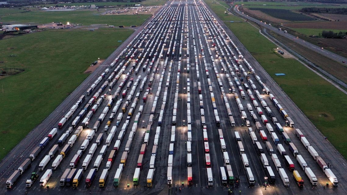 An aerial view shows lines of freight lorries and heavy goods vehicles parked on the tarmac at Manston Airport near Ramsgate, south east England. (AFP)